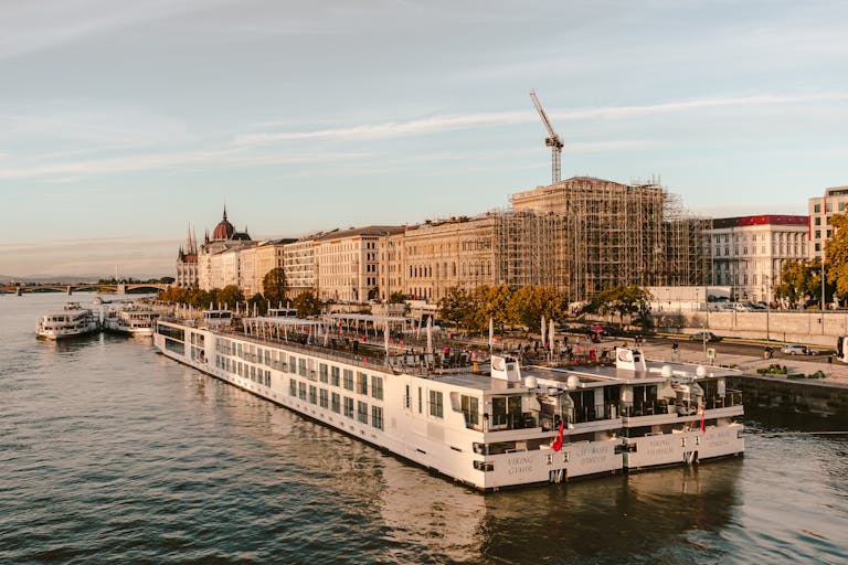 Scenic view of cruise boat on the Danube River with Budapest architecture.